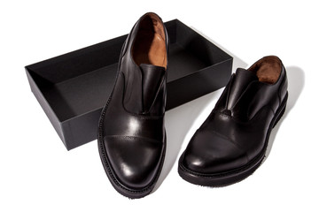 A pair of classic black colored laque leather boots