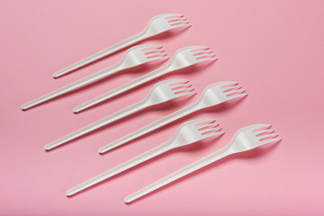 Plastic utensils, Forks, spoons, knives. Picnic dishes. not eco-friendly plastic. Environmental protection.