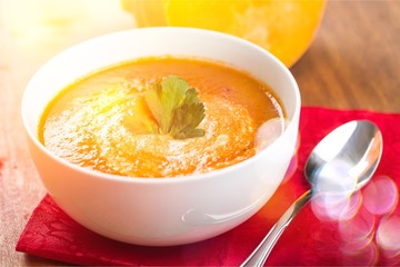 Tasty Pumpkin or  carrot soup on background