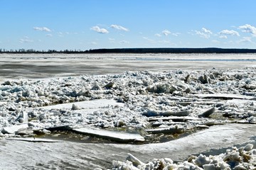 Huge blocks of breakaway ice float in the water in the spring on the river.