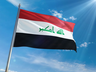 Naklejka na ściany i meble Iraq National Flag Waving on pole against sunny blue sky background. High Definition