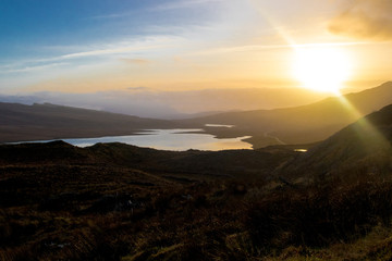 Contrast mountain landscape over highlands. Bright sblue sky over loch