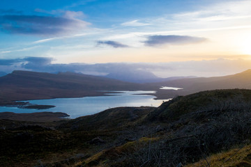 Fototapeta na wymiar Contrast mountain landscape over highlands. Bright sblue sky over loch