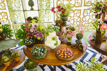 Wedding Setup. Cake tables with sweet, decoration and flowers 