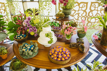Wedding Setup. Cake tables with sweet, decoration and flowers 
