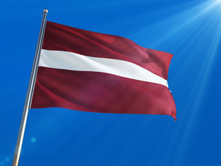 Fototapeta na wymiar Latvia National Flag Waving on pole against deep blue sky background. High Definition