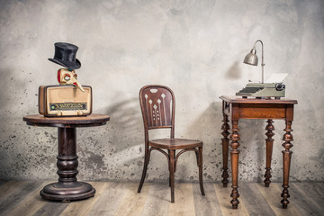 Vintage loft room with antique chair, broadcast radio, carnival mask, cylinder hat, old typewriter...