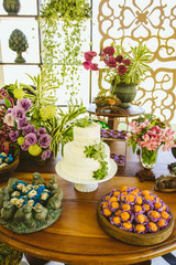 Fototapeta na wymiar Wedding Setup. Cake tables with sweet, decoration and flowers 