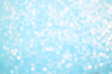 Obraz na płótnie Canvas Bokeh blurred blue background, Christmas and New Year holidays background. Party concept. Festive holiday card bright backdrop. Defocused. Flat lay, top view, copy space.