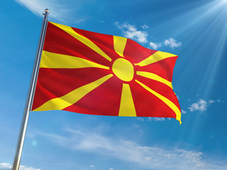 Macedonia National Flag Waving on pole against sunny blue sky background. High Definition