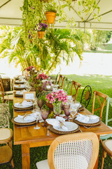 Wedding Setup. Banquet with table and chairs. Decoration, flowers, ware, glass