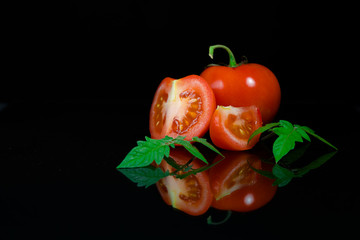 Fresh tomato on black background