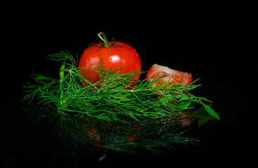 Fresh tomato on black background
