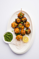 Tandoori aloo are roasted potatoes with Indian spices. It's a party appetiser served with green chutney. selective focus
