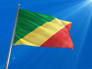 Republic Of The Congo National Flag Waving on pole against deep blue sky background. High Definition