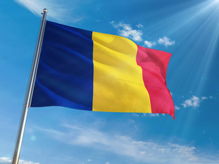 Romania National Flag Waving on pole against sunny blue sky background. High Definition