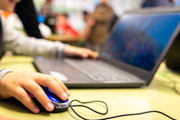 Valencia, Spain - April 13, 2019: Children using a laptop to play online.