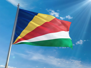 Seychelles National Flag Waving on pole against sunny blue sky background. High Definition
