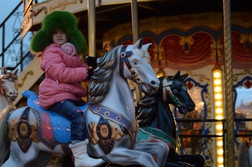 Fototapeta na wymiar Child on the carousel