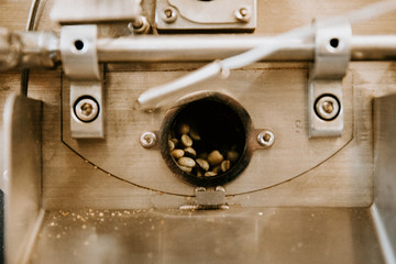 Organic Coffee Beans Roasting in an Industrial Coffee Bean Roaster and Cooling on Mechanical Stirring Pan