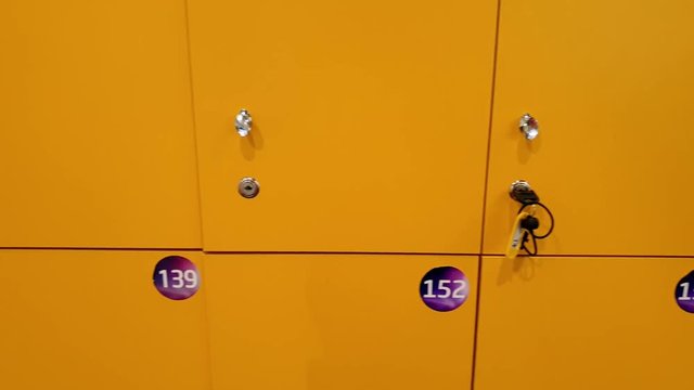 4k video of camera panning along row of locker doors in the gym