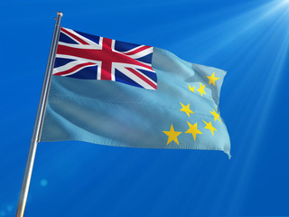 Fototapeta premium Tuvalu National Flag Waving on pole against deep blue sky background. High Definition