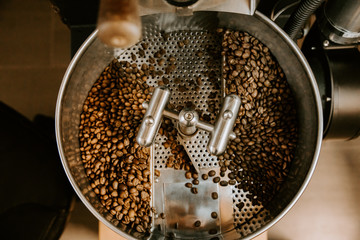 Organic Coffee Beans Roasting in an Industrial Coffee Bean Roaster and Cooling on Mechanical Stirring Pan