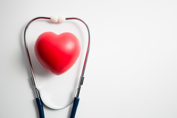 Red heart with stethoscope on white background