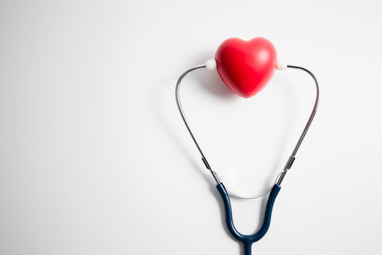 Red heart with stethoscope on white background