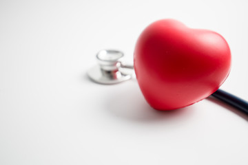Red heart with stethoscope on white background