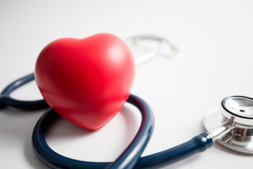 Red heart with stethoscope on white background