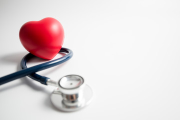 Red heart with stethoscope on white background
