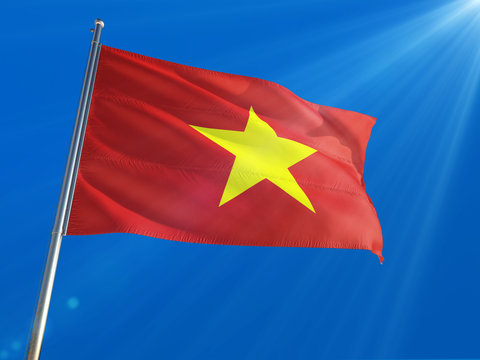 Vietnam National Flag Waving on pole against deep blue sky background. High Definition