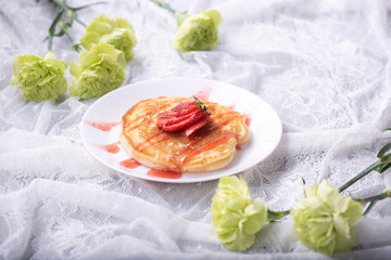 Pancakes with berries and maple syrup