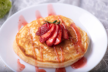 Pancakes with berries and maple syrup