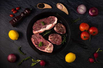 raw beef steak on wooden cutting board