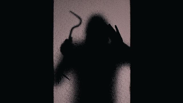 Silhouette of burglar with crowbar trying to break in house at night, robbery