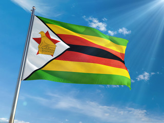 Zimbabwe National Flag Waving on pole against sunny blue sky background. High Definition