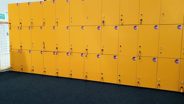 4k video of camera panning along row of locker doors in the gym