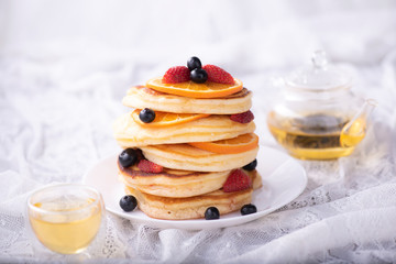 Pancakes with berries and maple syrup