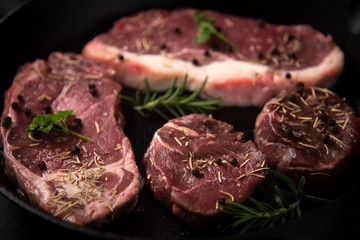 raw beef steak on wooden cutting board