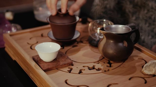 Man brews puer tea, dishes, chinese tea ceremony.