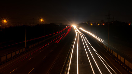 Fast driving vehicles trial at night, with long exposure blurred effect at Indian Nation Highway 2.