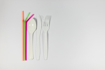 Plastic single use straws and cutlery, climate change topic, unsustainable and not eco friendly