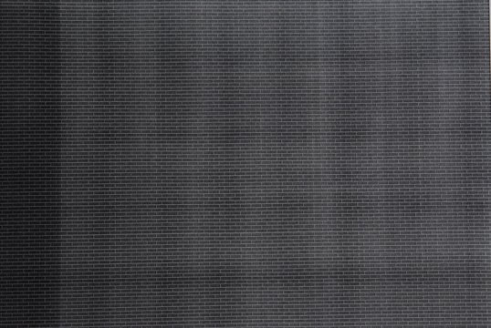 Brick pattern print to test black toner, Black paper texture background.