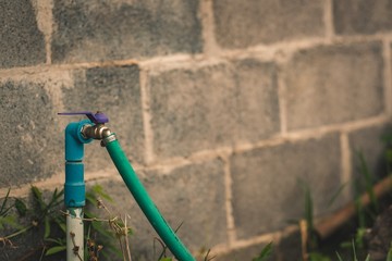 Closeup faucet with brick wall background