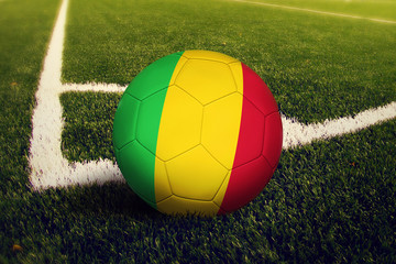 Mali ball on corner kick position, soccer field background. National football theme on green grass.