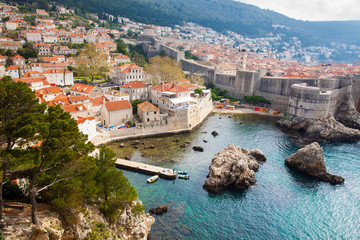 Fototapeta na wymiar Dubrovnik West Pier and medieval fortifications of the city seen from Fort Lovrijenac