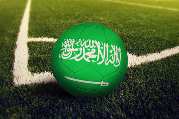 Saudi Arabia ball on corner kick position, soccer field background. National football theme on...