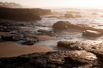 sunset on coast of sea